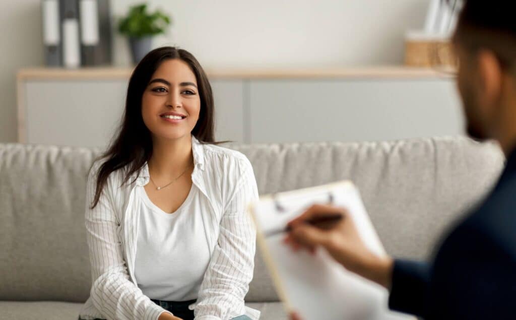 A woman smiling and engaged in addiction therapy in San Diego, California.