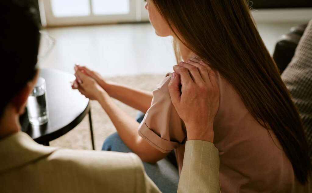 Woman receiving support during treatment at an Oceanside rehab center.