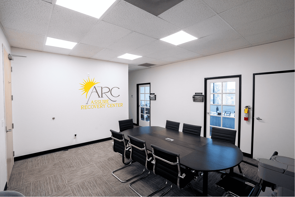 Bright therapy room with yellow chairs and large windows for natural light.