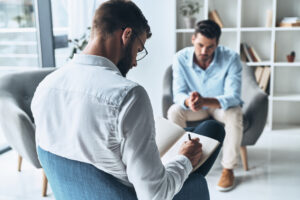 Young man discussing personal challenges during alcohol rehab for men in California.