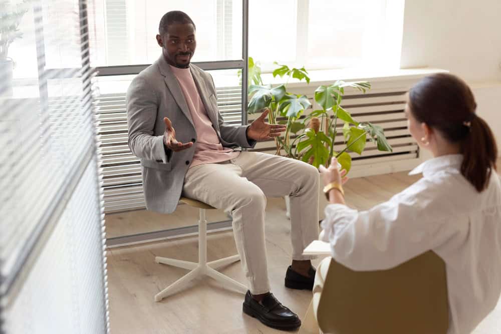Man speaking with his therapist during rehab for working professionals in San Diego.
